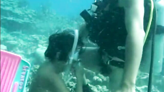 Scuba diver with young boy underwater in The Survivor eFukt video
