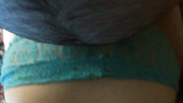 Closeup of woman's torn cyan thong pulled aside exposing bare pussy