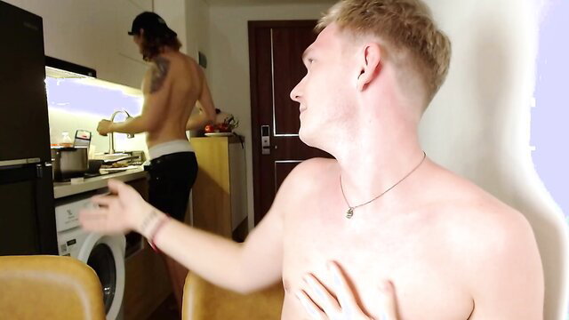 Blond muscular guy shirtless in underwear, tattooed friend cooking nude