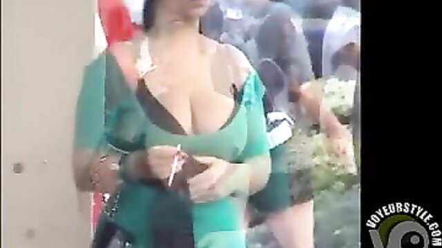 Latina senorita in deep cleavage green dress smoking outdoors
