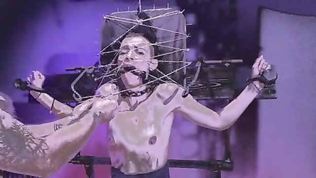 Submissive twink bound in spiked vulnerability chair, gagged and exposed
