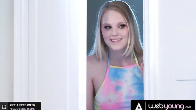Blonde Lily Rader in tie-dye dress peeking at teasing Latina Gina Valentina