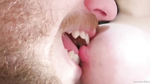 Bearded man sucking big natural tits of brunette girlfriend closeup