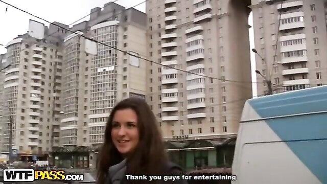 Busty brunette hottie smiles outdoors in front of Soviet apartments