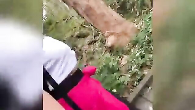 Amateur hike fun: woman in white shorts & pink top bends over outdoors with stranger