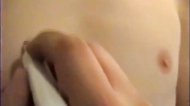 Goth hand stroking immense shaft on pale male chest closeup