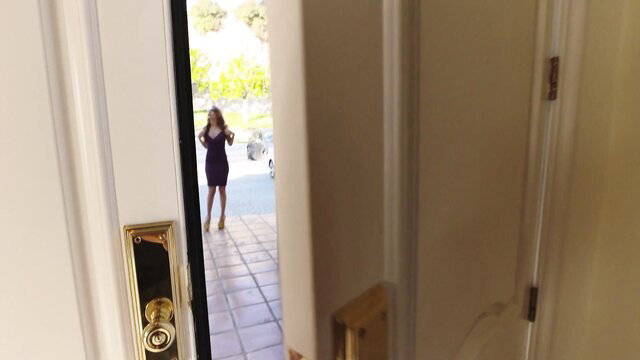 Kimmy Granger in tight purple dress at door, hot legs view