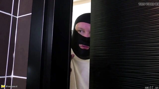 Masked man peeking through door in wet pissing mom fuck video