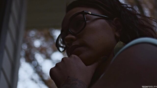 Harley Dean closeup in glasses, tattooed arm, sultry gaze