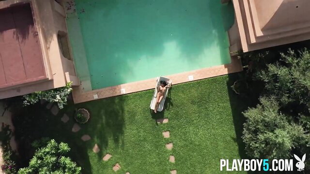 Big tits Asian MILF nude on pool lounger in Playboy hot shoot