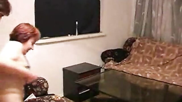 Young man gropes nude mature redhead milf on couch after drinking