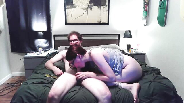 Lovableweirdos couple on bed, woman nuzzling man's neck intimately