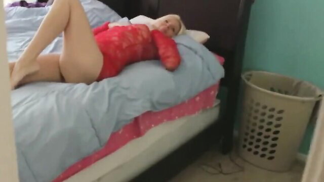 Blonde stepmom in red lace lingerie lounging seductively on bed