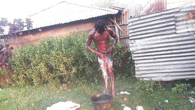 Naked African YouTuber with dreads showers nude outdoors, showing huge cock