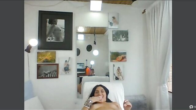 Sexy Latina MILF smiling topless in chair, playing with wet pussy