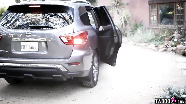 Kissa Sins' gray Nissan Rogue SUV with open door in outdoor scene