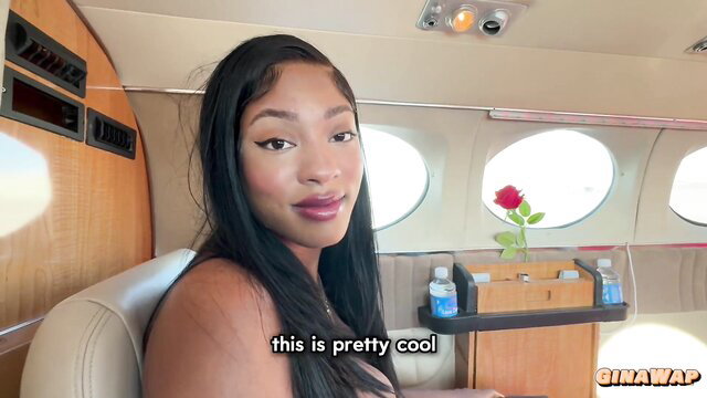 Hot black babe with braids smiles in luxury private jet