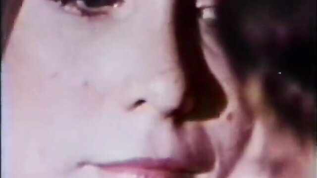 Closeup of pretty retro Asian girl's seductive face in vintage xxx video