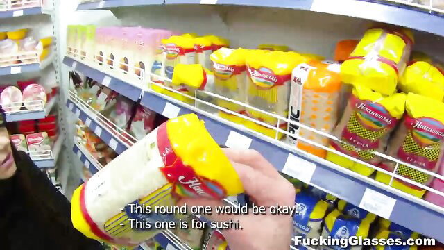 Asian teen in store grabs yellow wasabi tube playfully, POV tease
