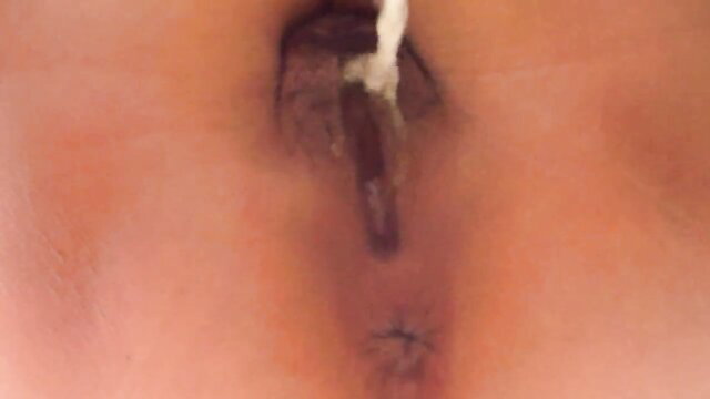 Close-up of Chinese girl pissing in toilet, urine stream visible