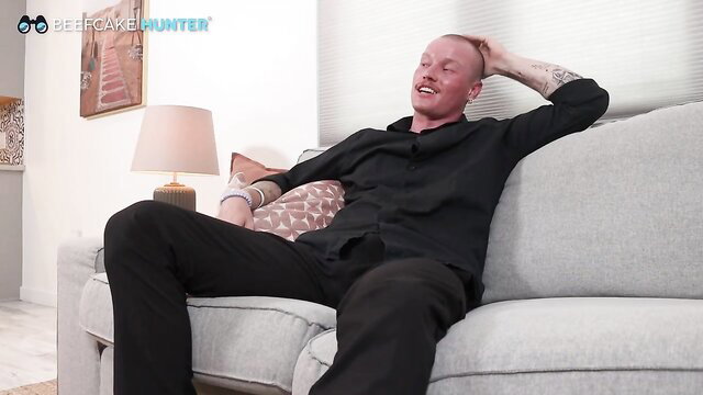Bald muscular man Axel relaxes on couch in Axel's First Time