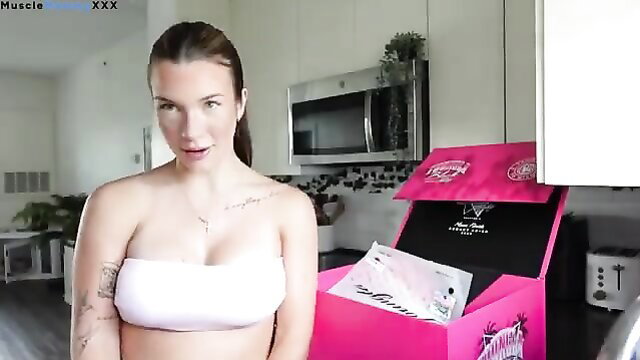 Tattooed brunette in white tube top unboxing pink sex toy box vlog