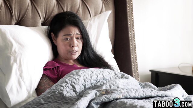 Kylie Rocket's Asian stepmom in bed, upset expression, tattooed arm