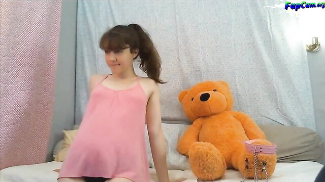 Cute 18yo Asian amateur babe in pink dress on bed with teddy bear