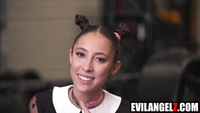 Cute Asian painter in pigtails smiles in sexy black dress choker