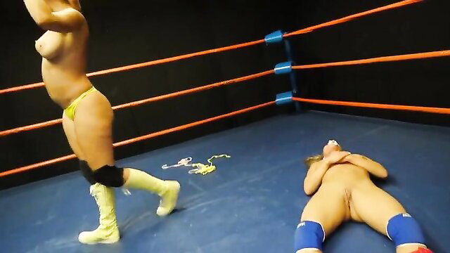 Blonde wrestler dominates nude opponent in ring, exposed pussy