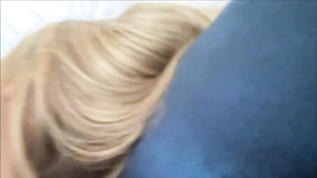 Angie Faith's blonde hair on blue pillow, teasing closeup