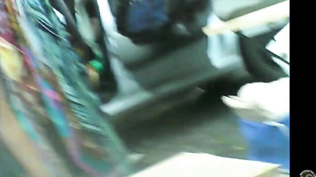 Saleswoman bends over, cleavage spilling out from low-cut top