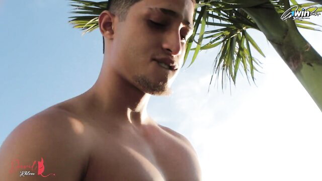 Hot Latino Milan Rodriguez shirtless outdoors under palm tree