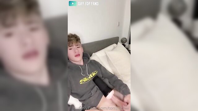Tom Baker twink in hoodie stroking cock on bed solo