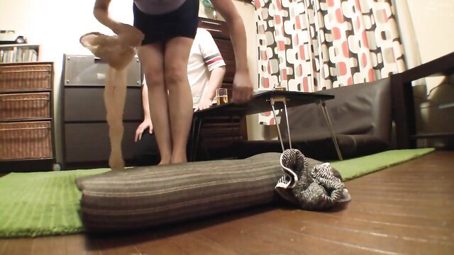 Japanese mature wife mother standing over table in shorts, frustrated MILF tease