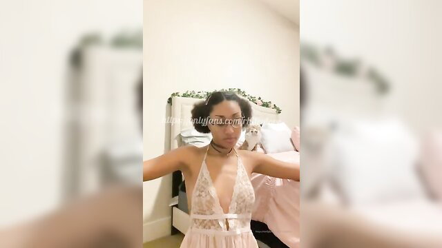 Rhiley Love in sheer white lace lingerie, arms spread teasing