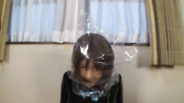 Asian rubber girl in tight latex hood bag breathplay restraint shame