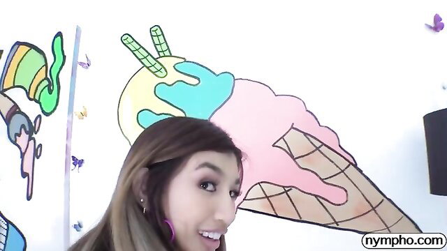 Clara Trinity smiling in colorful room, teasing with stiff tits