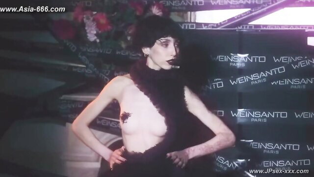 Braless Asian model in sheer black fashion gown, topless trend style