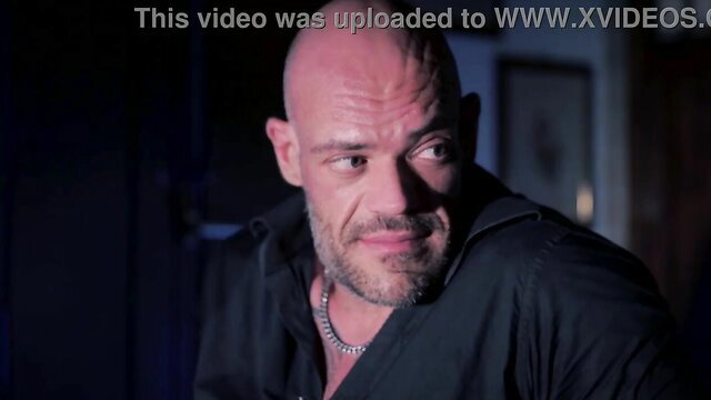 Bald muscular man intense stare in The Three Keys of Terror short with Suzie Q
