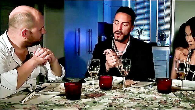 Suzie Q dines intimately with bald man and suited guy at candlelit table