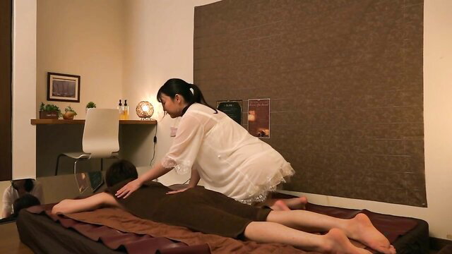 Asian masseuse in white dress gives close contact forbidden massage to nude male client