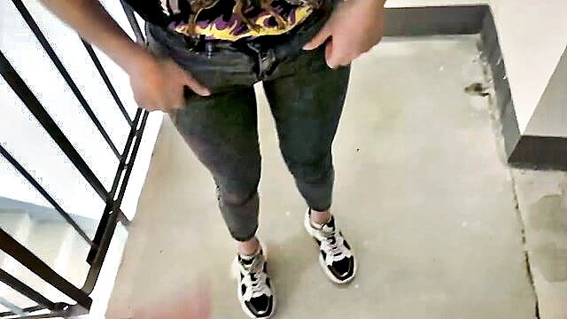 Asian woman in tight jeans and sneakers on balcony, risky public tease