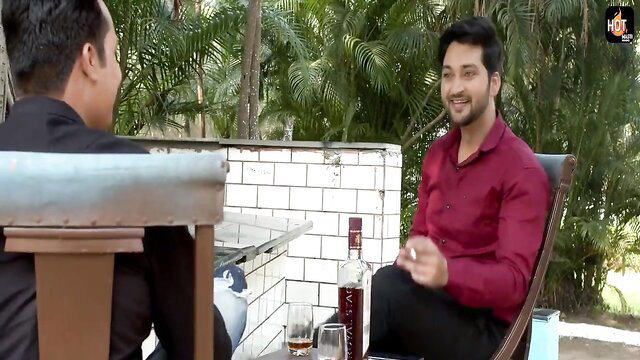 Ankita Dave chats intimately with man outdoors, whiskey glass