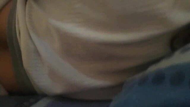 Stepmom in white shirt and blue shorts sleeps with stepson on bed