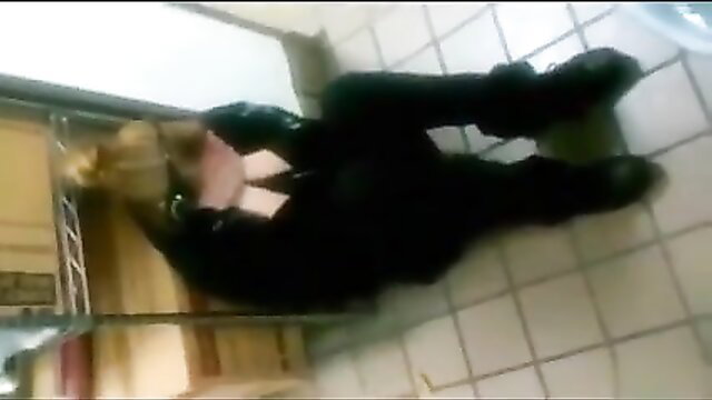 Blonde in latex pants squats peeing on public bathroom floor