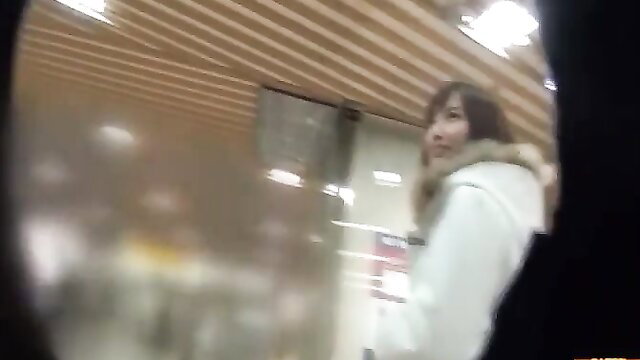 Japanese cutie in white fur-trimmed coat at station