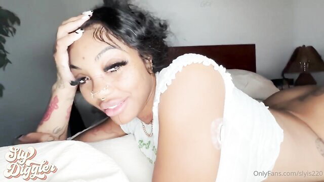 Brandi x Sly sexy pose on bed in white top, thick ebony babe