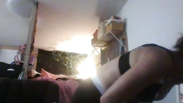 Lacieextreme in black bra and shorts, bending over on bed