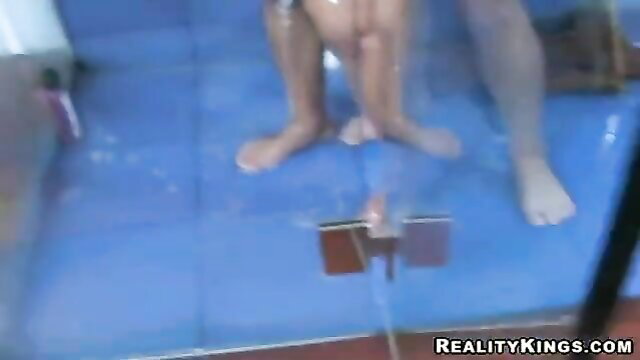 Two sexy babes showering together on blue mats, fucking wildly